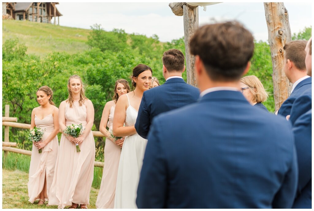 Tris & Jana - Lumsden Wedding - 18 - Bride steals a glance at the groom