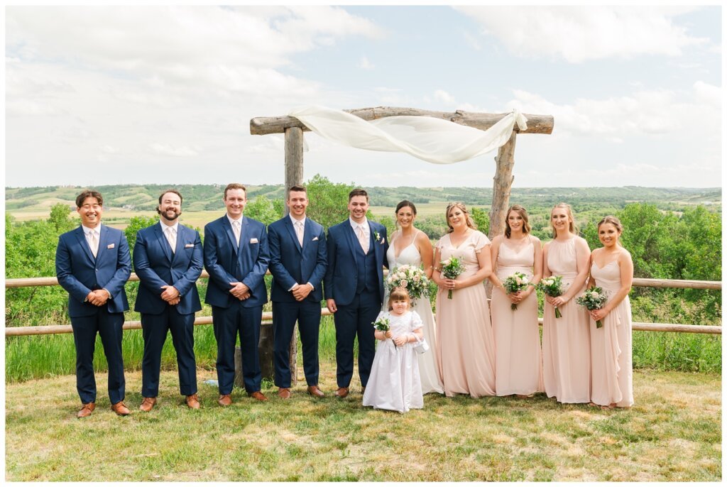 Tris & Jana - Lumsden Wedding - 20 - Bride & Groom stand with their bridal party