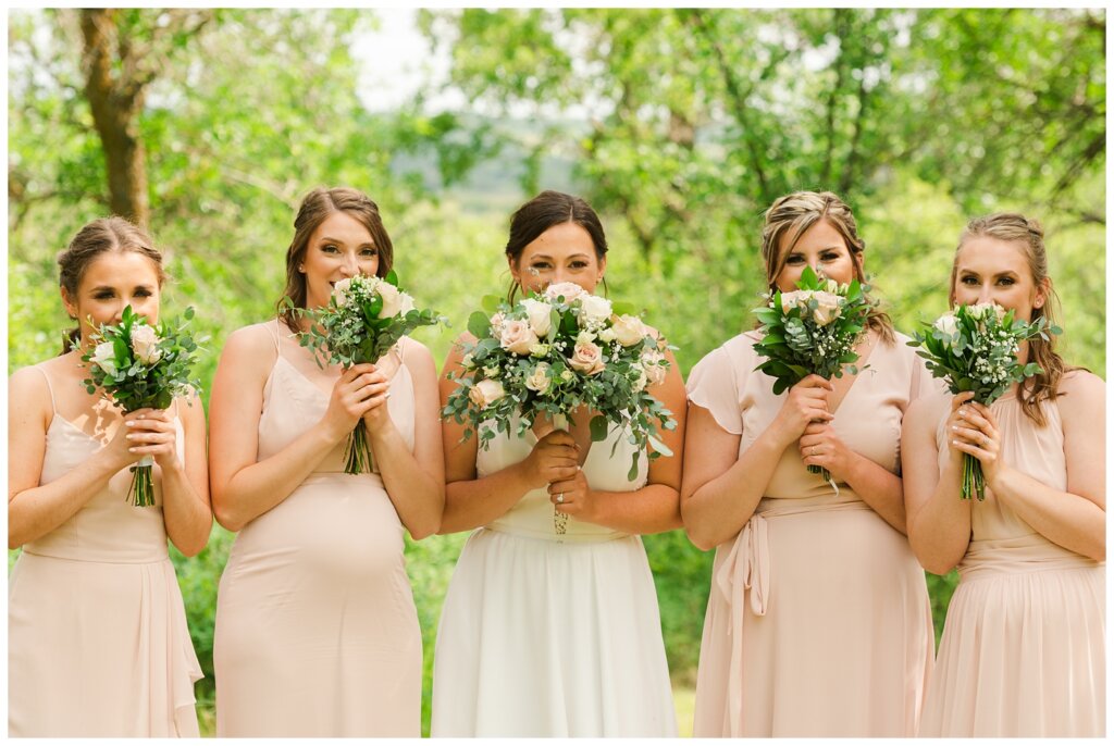 Tris & Jana - Lumsden Wedding - 23 - Bride & bridesmaids pose with their flowers from The Flower Hut Regina