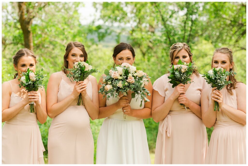 Tris & Jana - Lumsden Wedding - 23 - Bride & bridesmaids pose with their flowers from The Flower Hut Regina