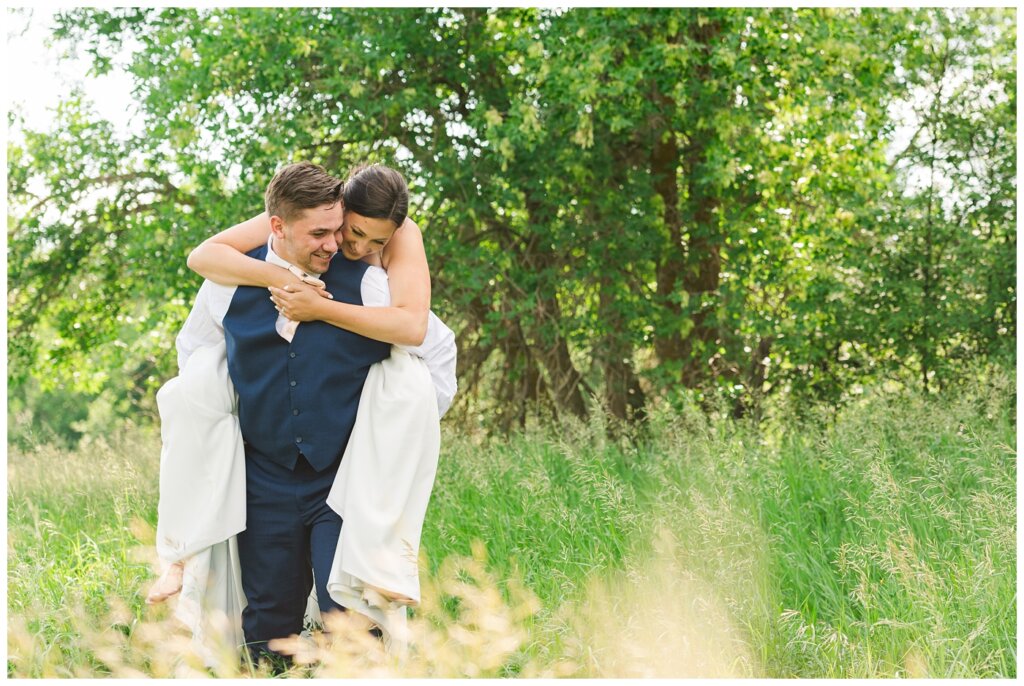 Tris & Jana - Lumsden Wedding - 29 - Groom gives his bride a piggyback