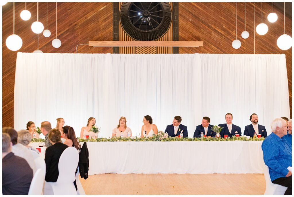 Tris & Jana - Lumsden Wedding - 35 - Bridal party seated at the head table