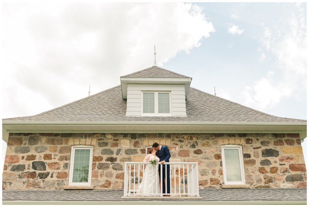 Ben & Megan - 19 - Regina Wedding - Bride & Groom share a kiss on the balcony