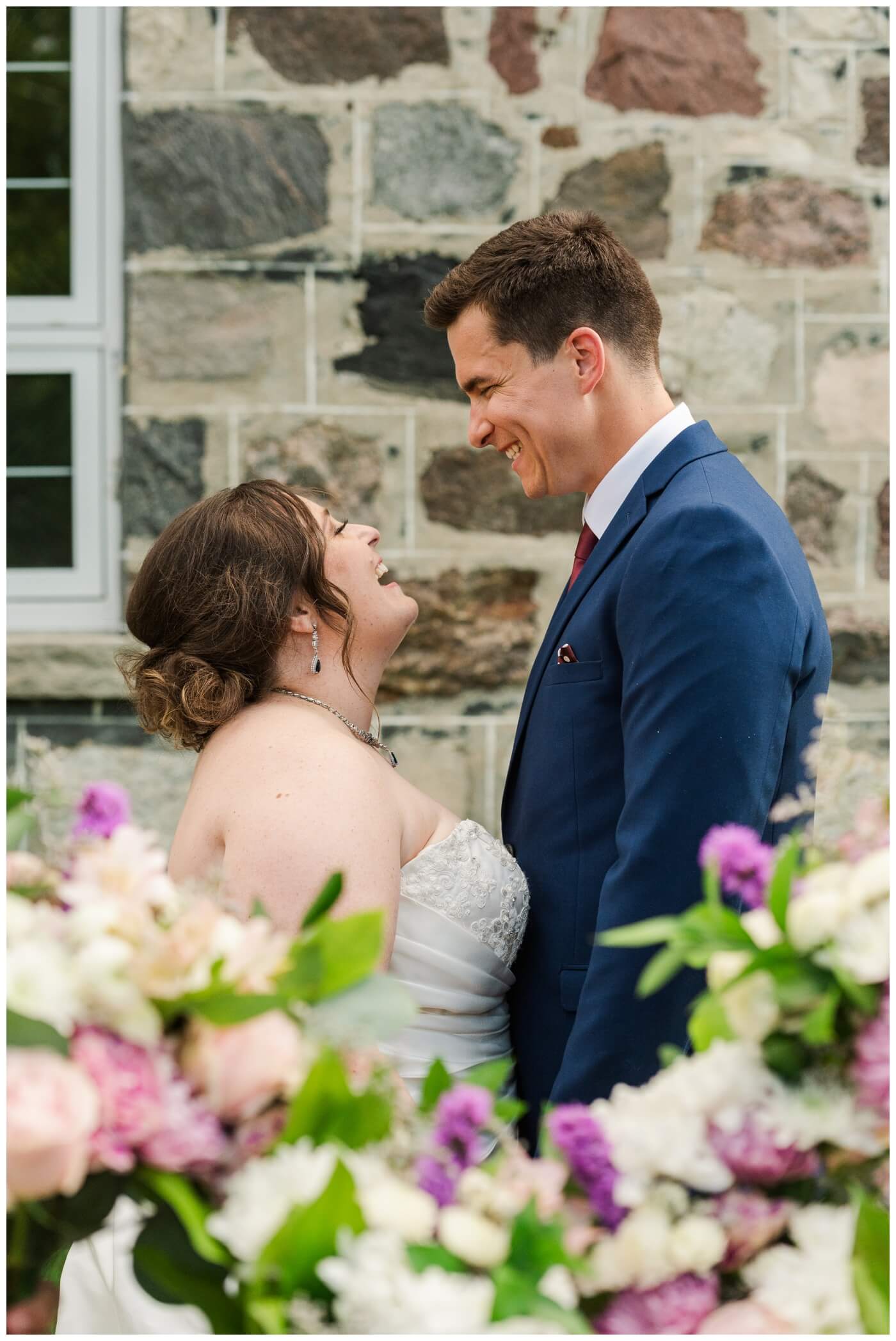 Ben & Megan - 23 - Regina Wedding - Bride & groom through the flowers