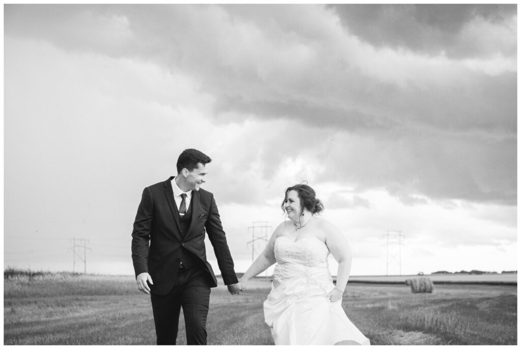 Ben & Megan - 30 - Regina Wedding - Bride & Groom run from the storm