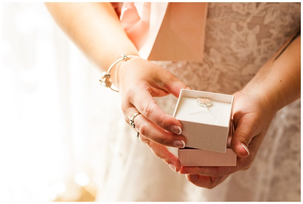 Andrew & Alisha - Regina Wedding Photography - 10 - Bride receives moongate necklace from Bermuda