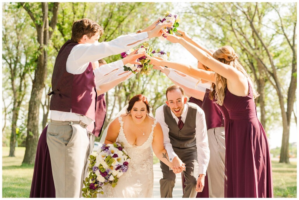 Andrew & Alisha - Regina Wedding Photography - 27 - Bride & Groom run through tunnel arch in celebration