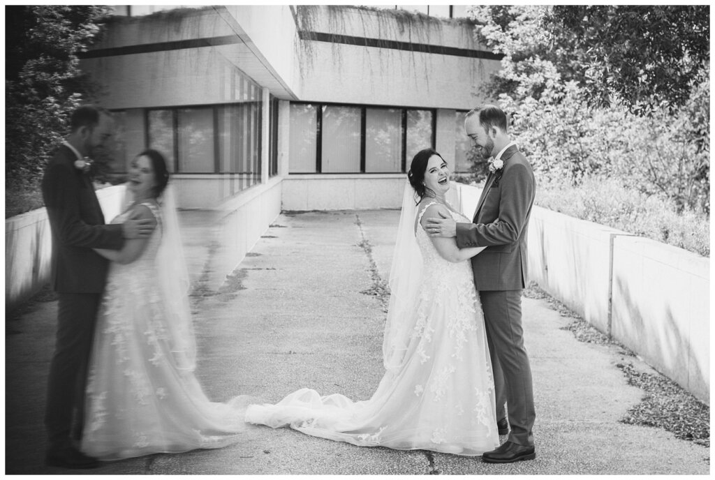 Andrew & Alisha - Regina Wedding Photography - 28 - Bride & Groom laugh outside the TC Douglas Building