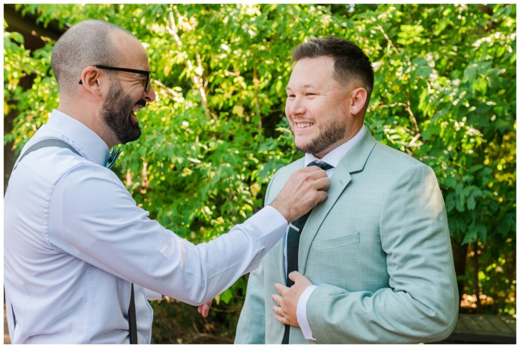 Declan & Katherine - 03 - Regina Wedding - Groomsmen helps groom adjust in his mint suit