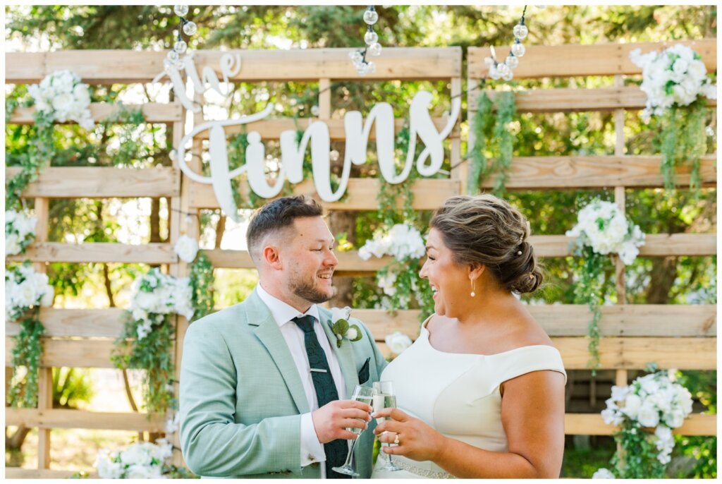 Declan & Katherine - 40 - Regina Wedding - The Finns in front of wooden backdrop