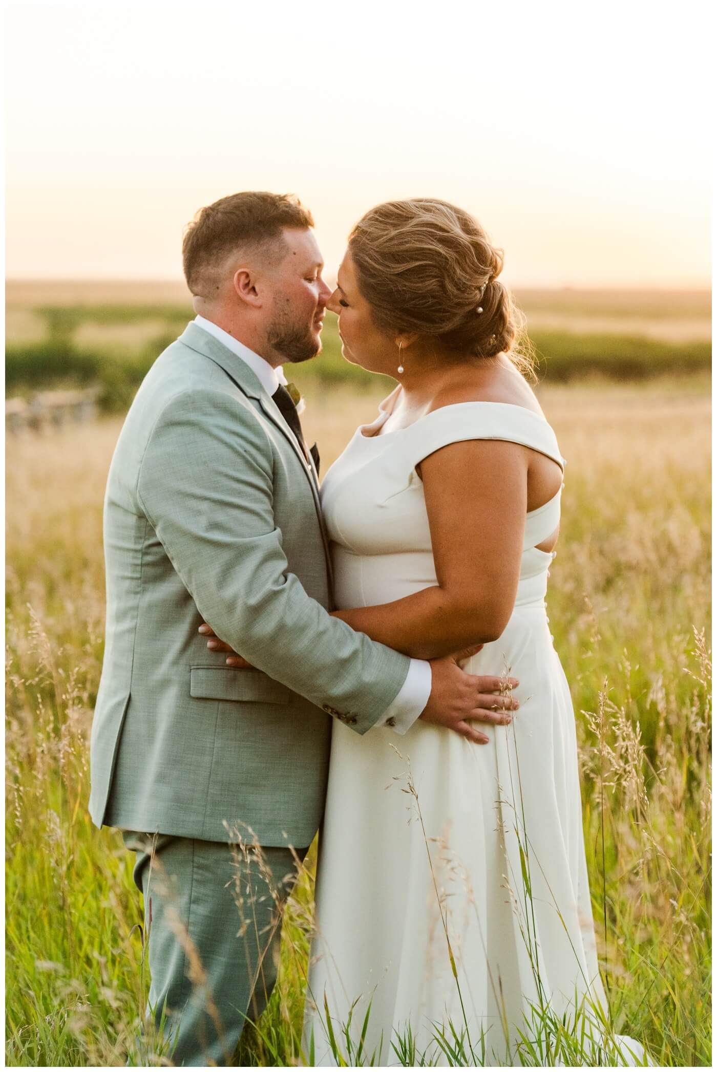 Declan & Katherine - 44 - Regina Wedding - Bride & groom kiss in field of tall grass