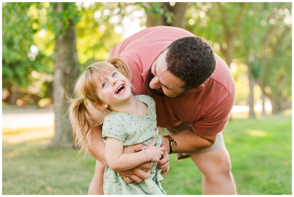 Eyre Family - 11 - Regina Family Little girl with pigtails giggles in daddys arms