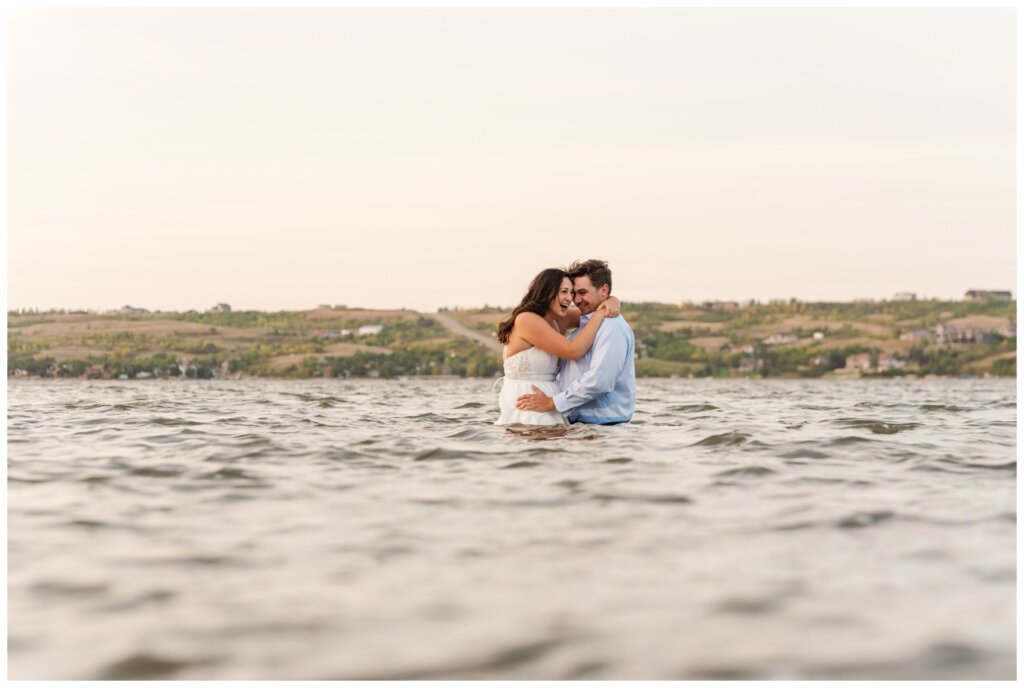 Tris & Jana - 14 - Regina Encore Session - Bride & Groom walk out into the lake