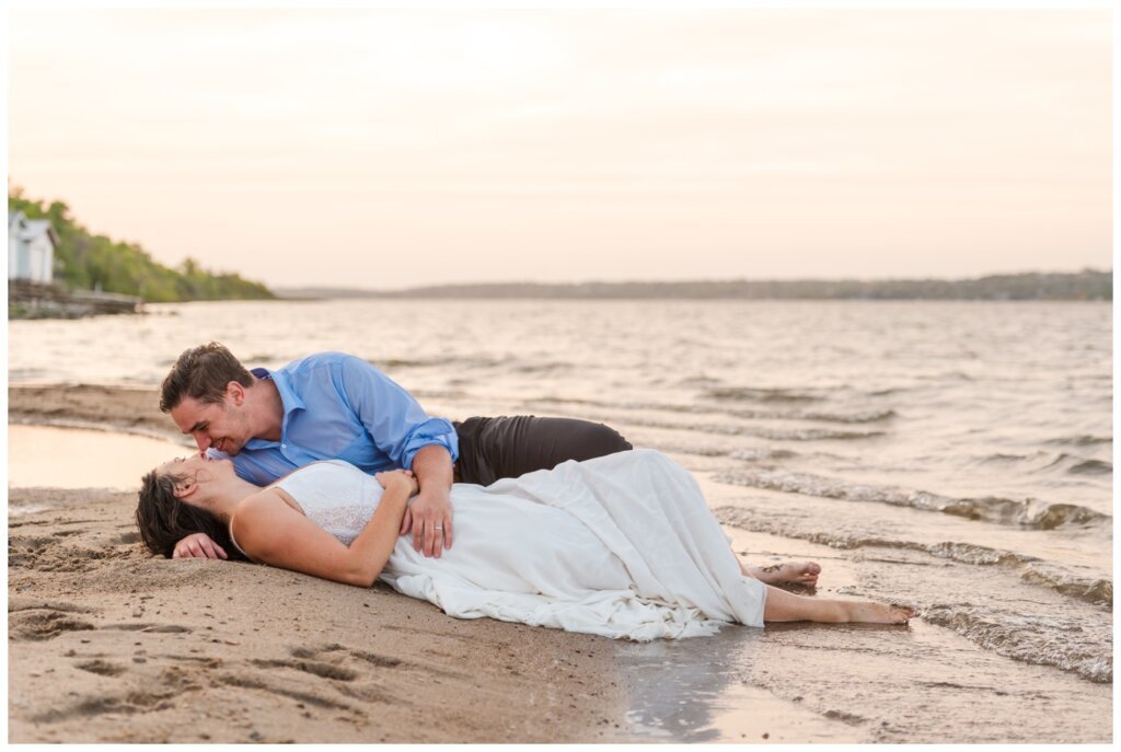 Tris & Jana - 17 - Regina Encore Session - Bride & groom lay in the surf on the beach