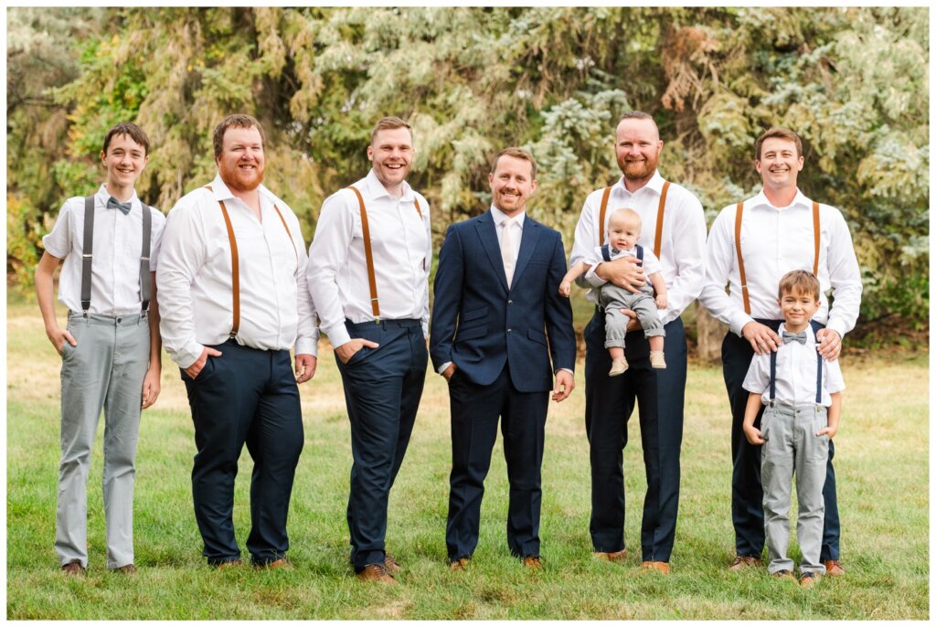 Adam & Caitlin - 01 - Regina Wedding - Groom in his navy blue suit with his groomsmen