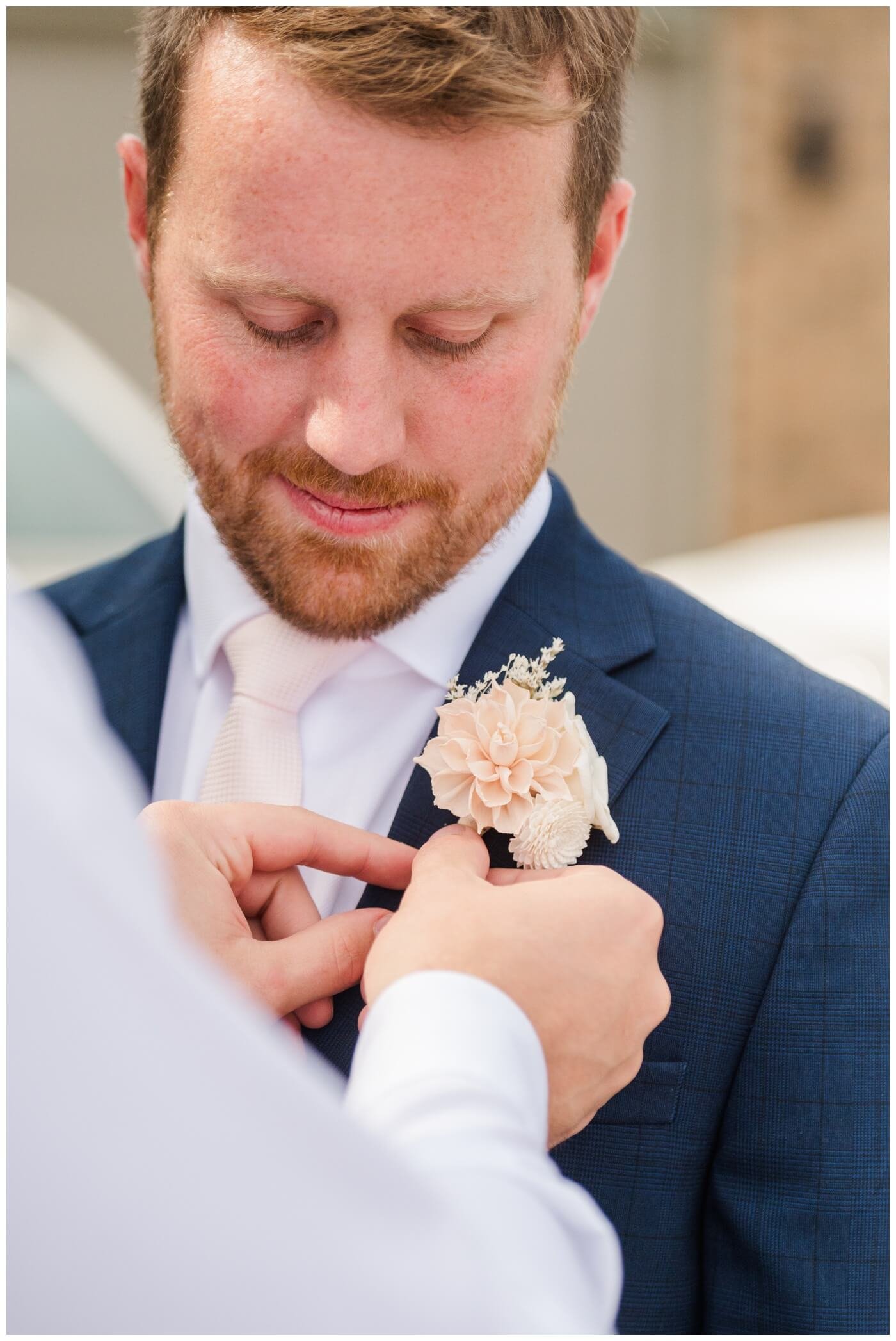 Adam & Caitlin - 04 - Regina Wedding - Groom gets his boutonneire pinned on