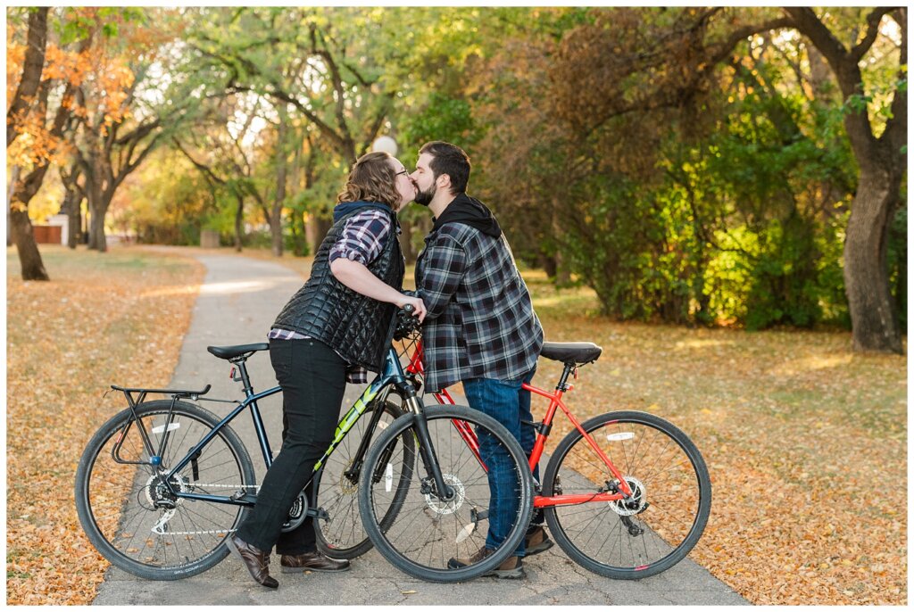Jared & Haley - Engagement Session - 02 - Couple on bikes kissing over handle bars