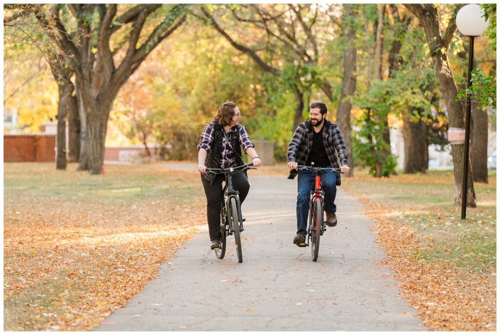 Jared & Haley - Engagement Session - 03 - Couple riding their bikes through Wascana Park