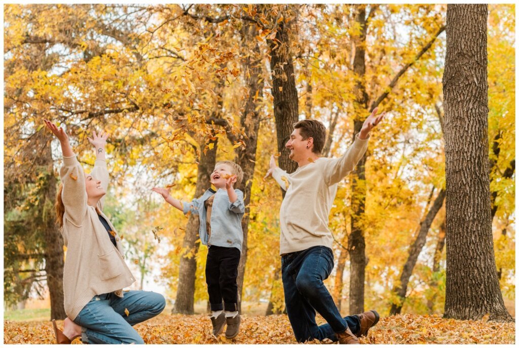 McFie Family - 10 - Regina Family Session Fmily throws fallen leaves like confetti