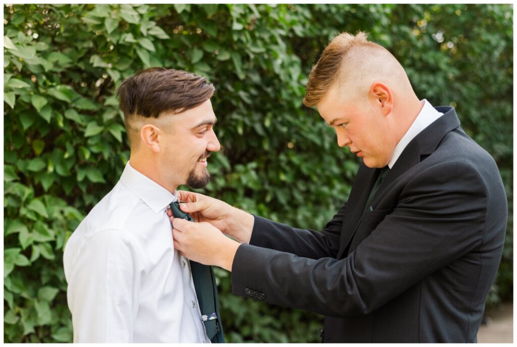 Orrin & Jade - 02 - Weyburn Wedding - Groomsmen helps groom with his tie