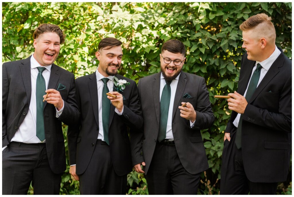 Orrin & Jade - 04 - Weyburn Wedding - Groom & groomsmen share in a cigar