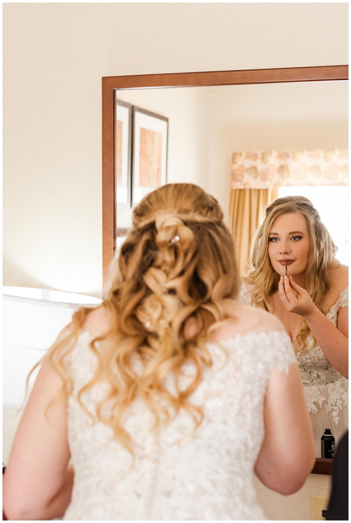 Orrin & Jade - 11 - Weyburn Wedding - Bride applies her lipstick in the mirror