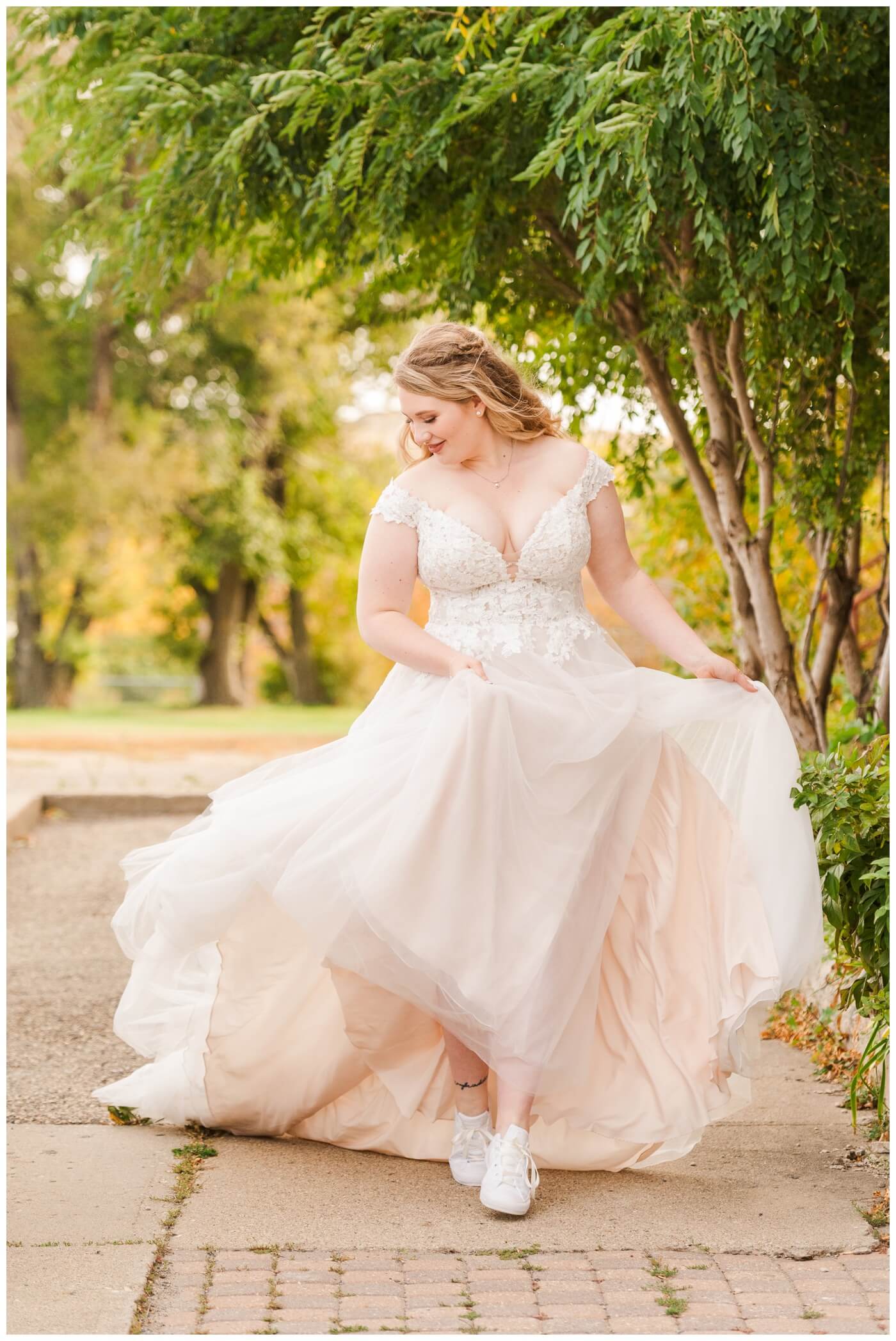 Orrin & Jade - 23 - Weyburn Wedding - Bride looks like a princess as she walks under a tree