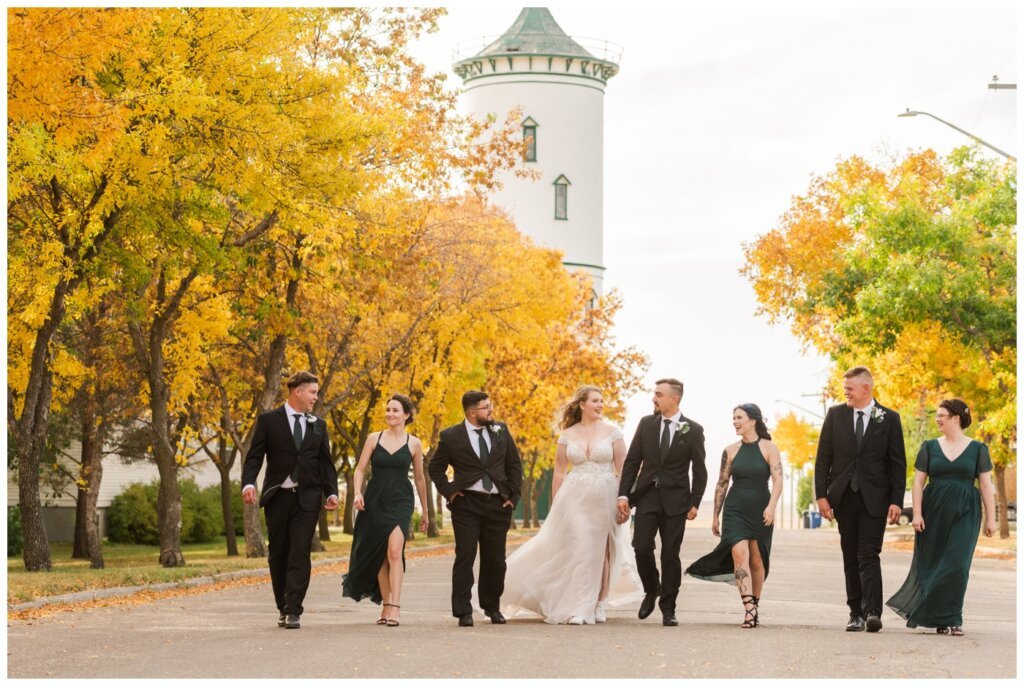 Orrin & Jade - 26 - Weyburn Wedding - Bridal party walks in front of the water tower