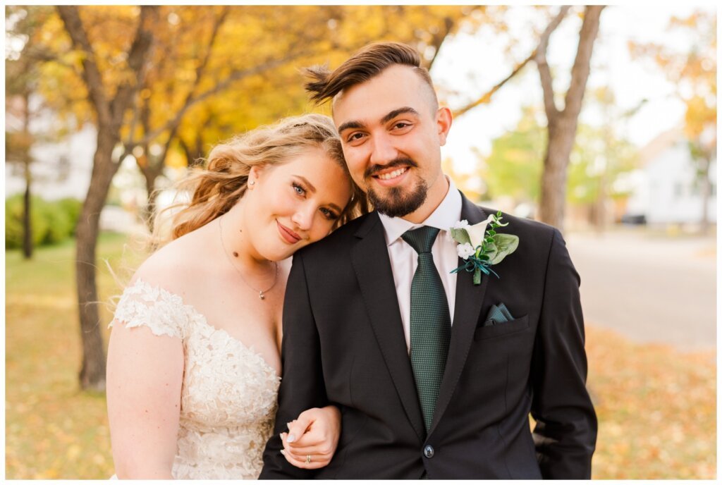 Orrin-Jade-31-Weyburn-Wedding-Bride-holds-onto-her-groom