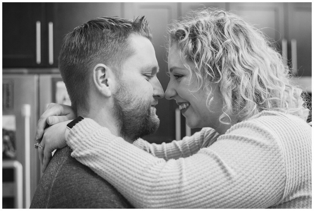 Tyrel & Allison - Winter 2022 - 05 - Wife sitting on kitchen island as husband nuzzles in