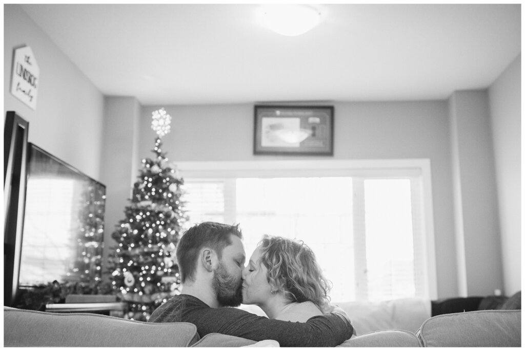 Tyrel & Allison - Winter 2022 - 07 - Couple kissing near their Christmas tree