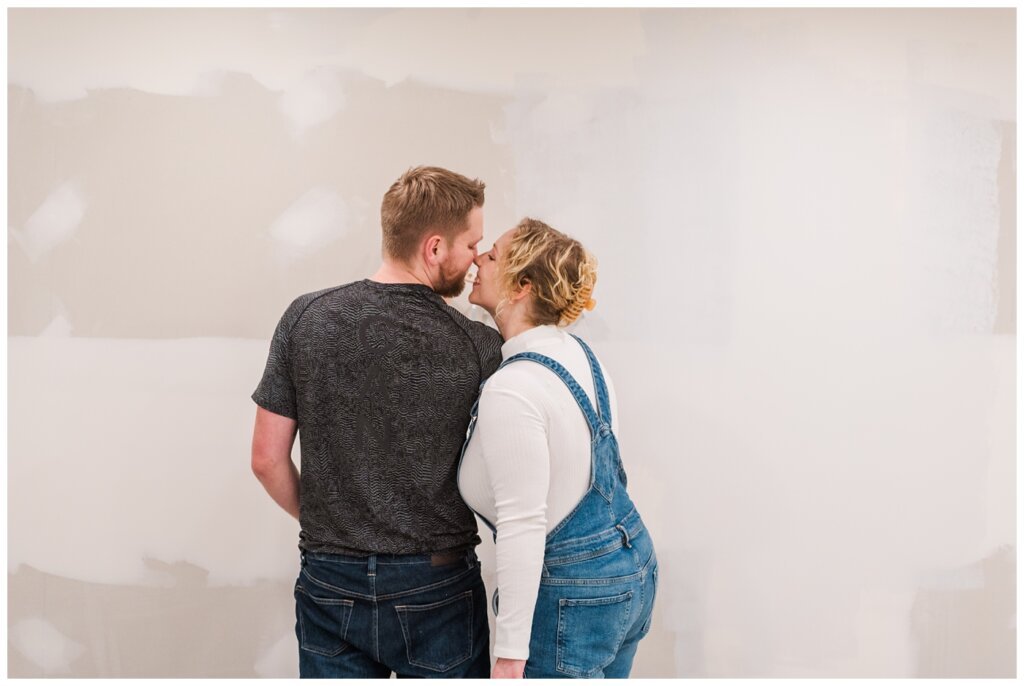 Tyrel & Allison - Winter 2022 - 08 - Basement renos while couple leans in for a kiss