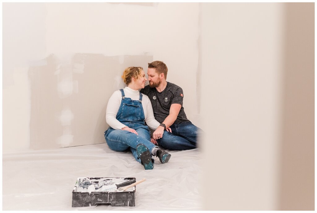 Tyrel & Allison - Winter 2022 - 09 - Couple sitting in their partially renovated basement