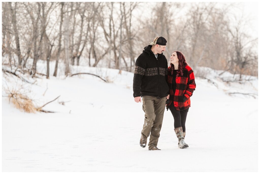 Brett & Brittany - Winter 2023 - Lumsden Valley - 07 - Couple walks through the snow