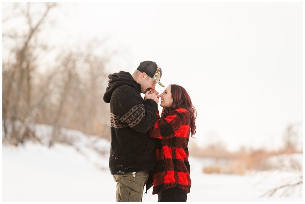 Brett & Brittany - Winter 2023 - Lumsden Valley - 08 - Husband warms his wifes hands