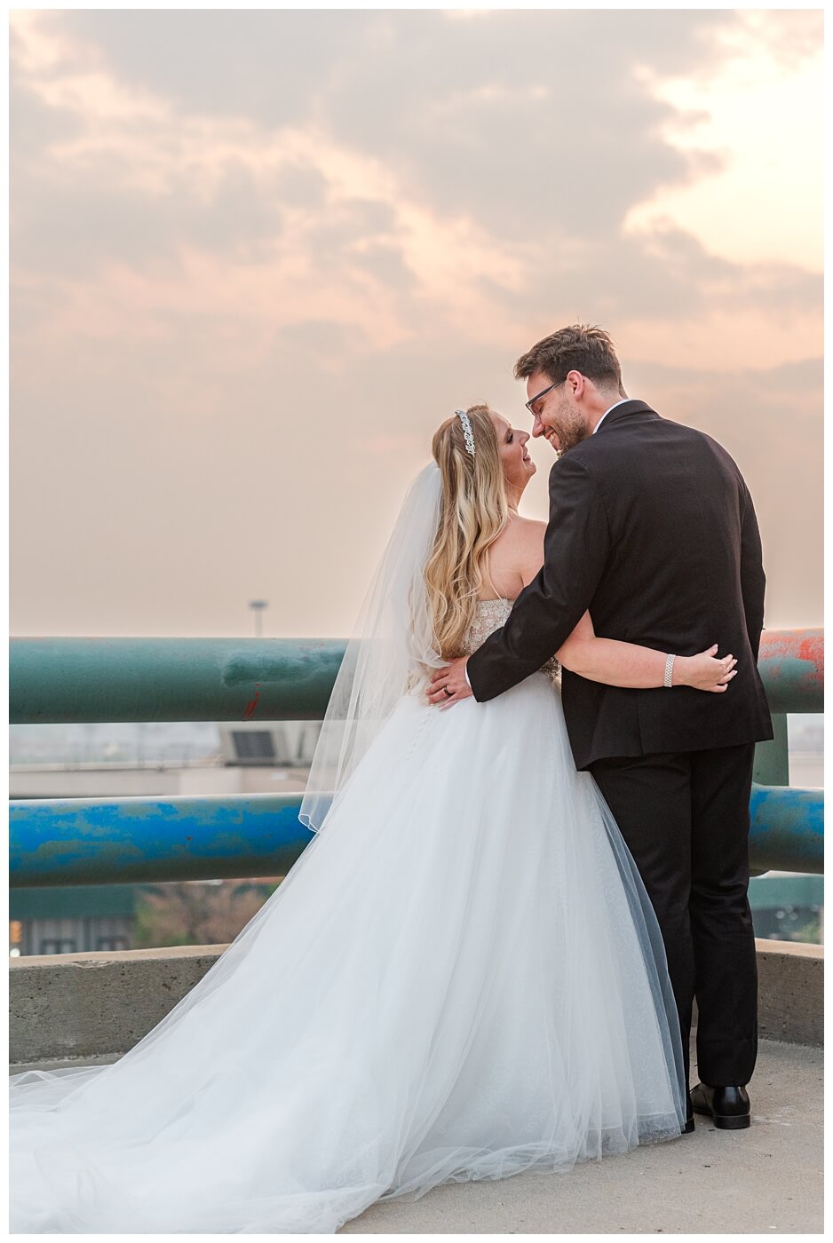 Brett & Rachelle - Delta Regina Wedding - 22 - Couple's Kiss at Sunset on Parkade roof