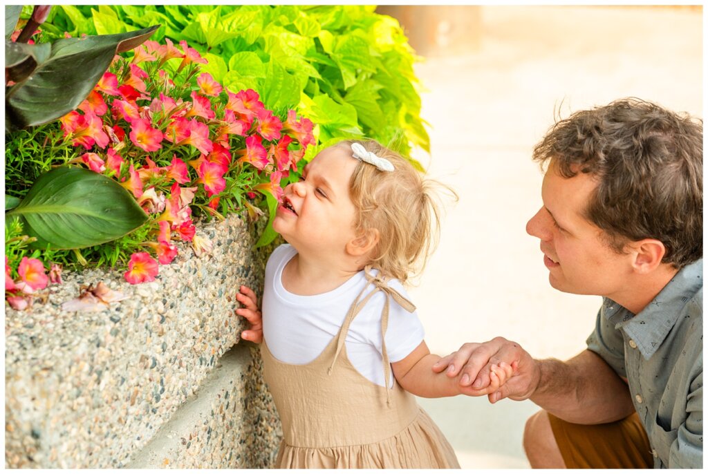 Filby Family 2023 - 01 - Little girl stops to smell pink flowers