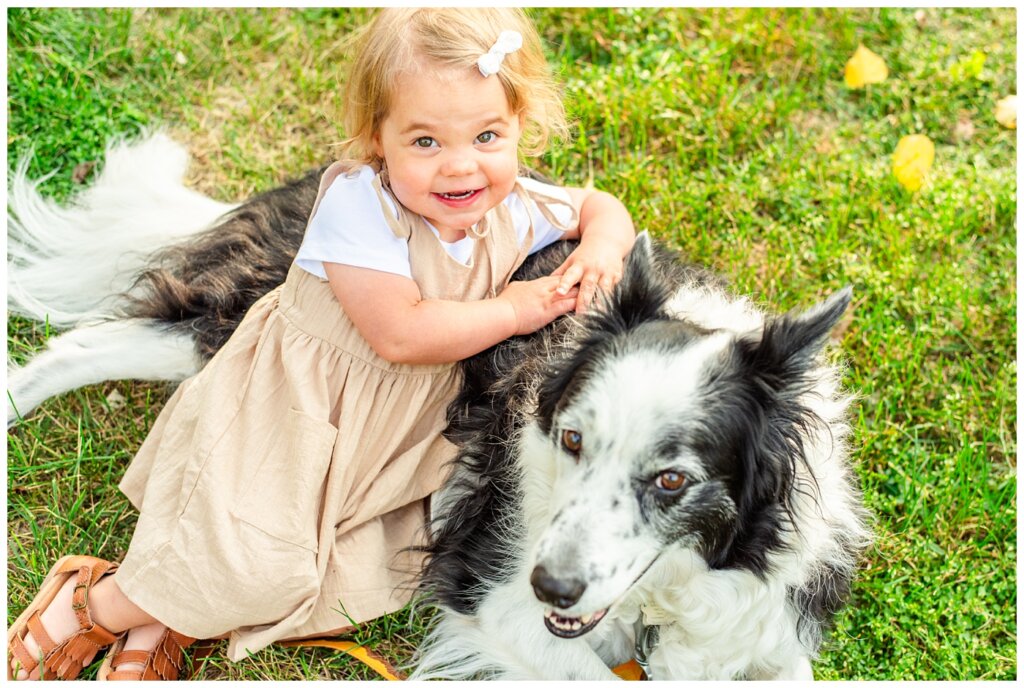 Filby Family 2023 - 03 - Little girl cuddles with her black and white dog