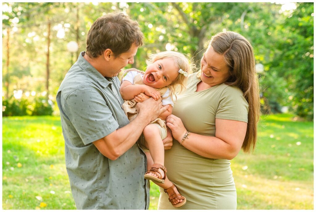 Filby Family 2023 - 10 - Little girl laughs as she is tickled by her parents