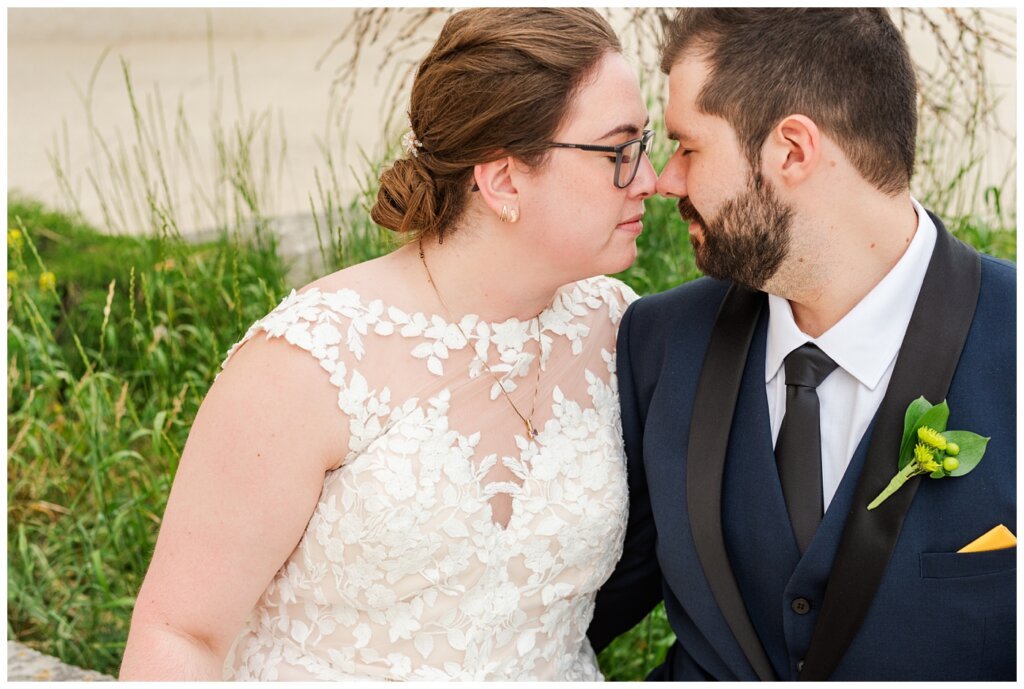 Jared & Haley - 24 - Bride & Groom eyes closed and touching noses at TC Douglas Buidling