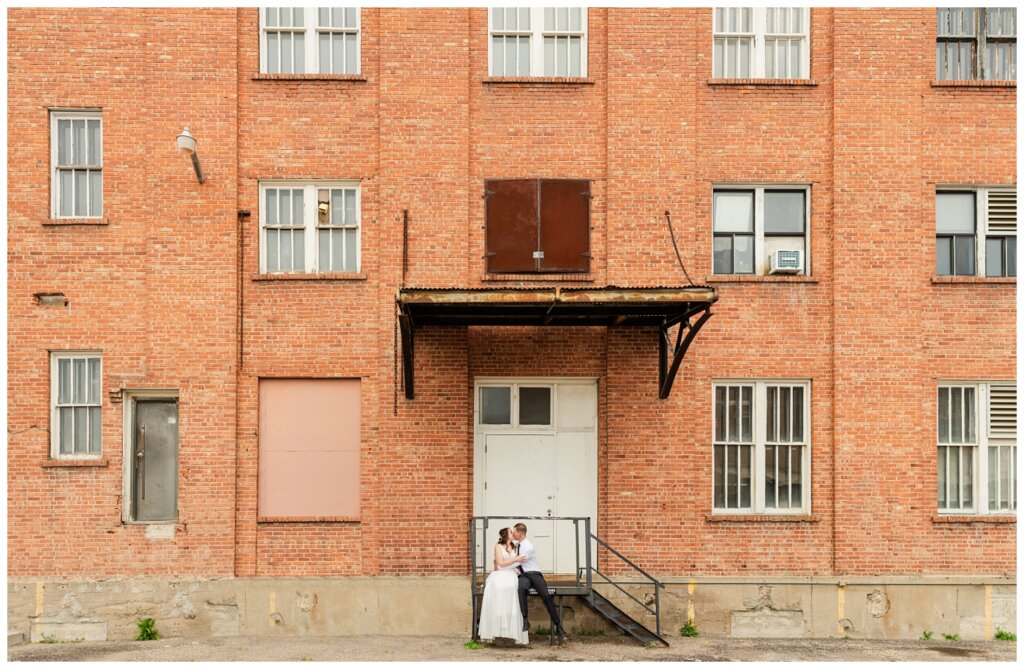 Ryan & Melissa - Hotel Sask Wedding - 23 - Wide shot of bride and groom in back alley