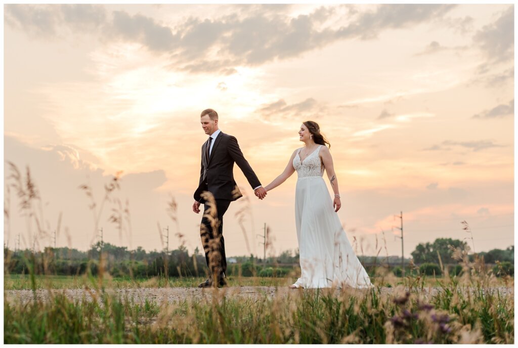 Ryan & Melissa - Hotel Sask Wedding - 25 - Bride & Groom walking at sunset