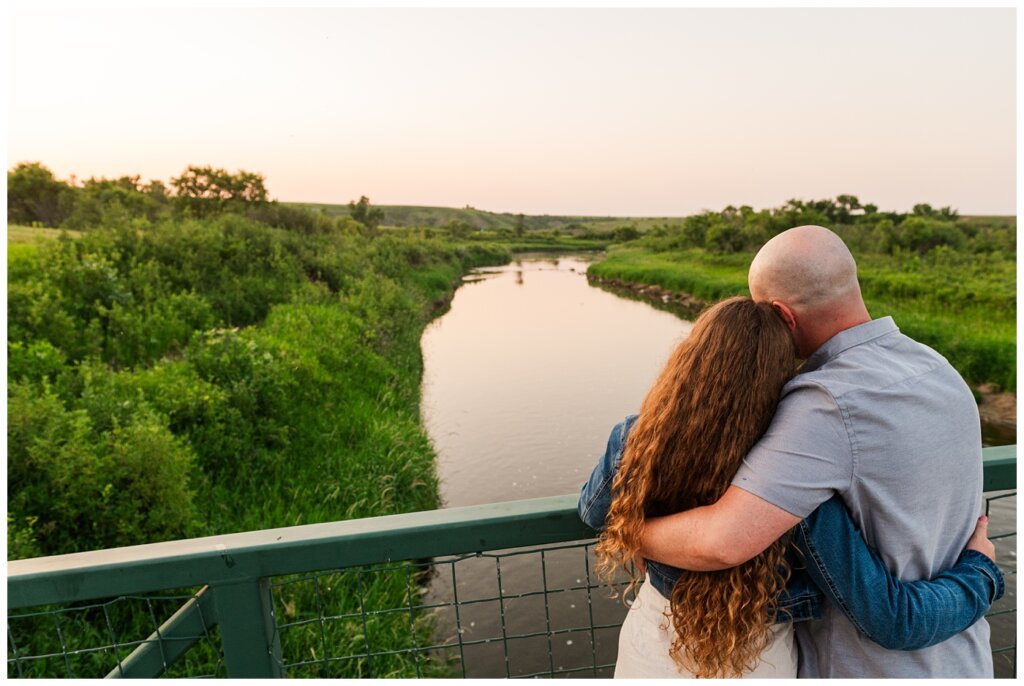 Spencer & Taylor - 09 - Couple staring out over bridge at wascana trails