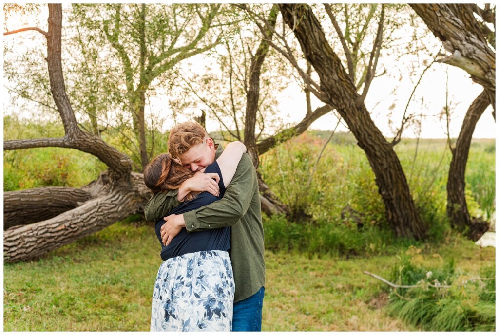 Kenny-Marrick-Engagement-Our-Lady-of-Lourdes-Shrine-04-Groom-to-be-wraps-his-fiance-in-a-big-hug