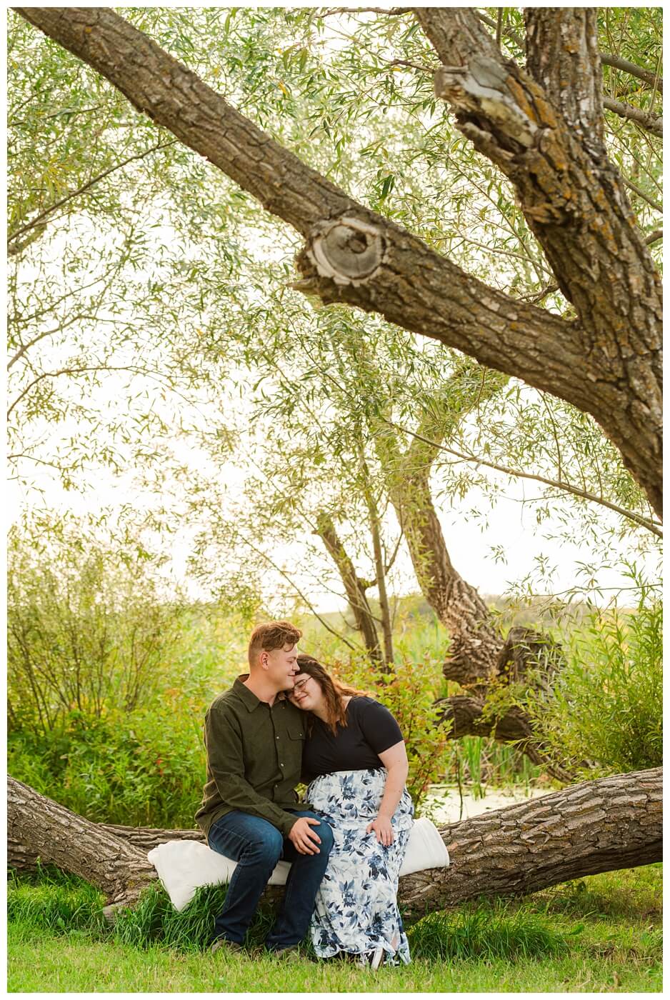 Kenny-Marrick-Engagement-Our-Lady-of-Lourdes-Shrine-05-Couple-sit-under-a-large-tree