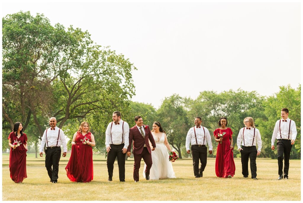 Luis & Keila - Summer wedding 2023 - Les Sherman Park - 12 - Bridal party walking through the grass
