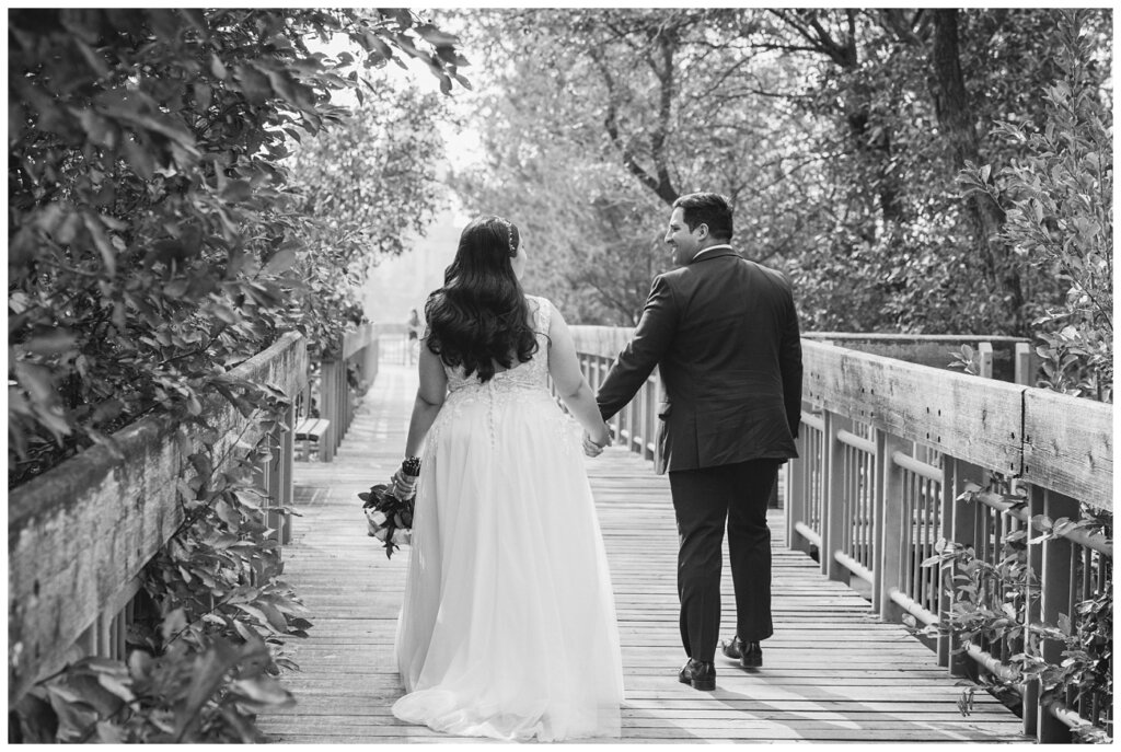 Luis & Keila - Summer wedding 2023 - Trafalgar Overlook - 20 - Groom leads his bride down the wooden overlook