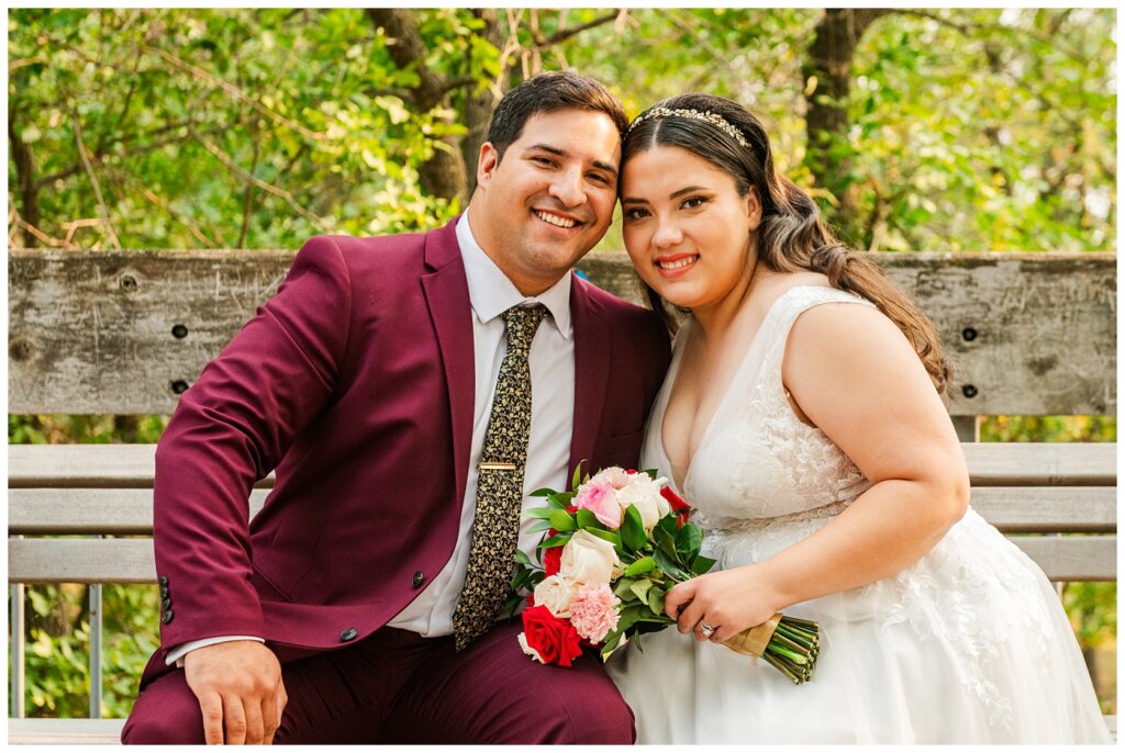 Luis & Keila - Summer wedding 2023 - Trafalgar Overlook - 26 - Husband & wife on a bench