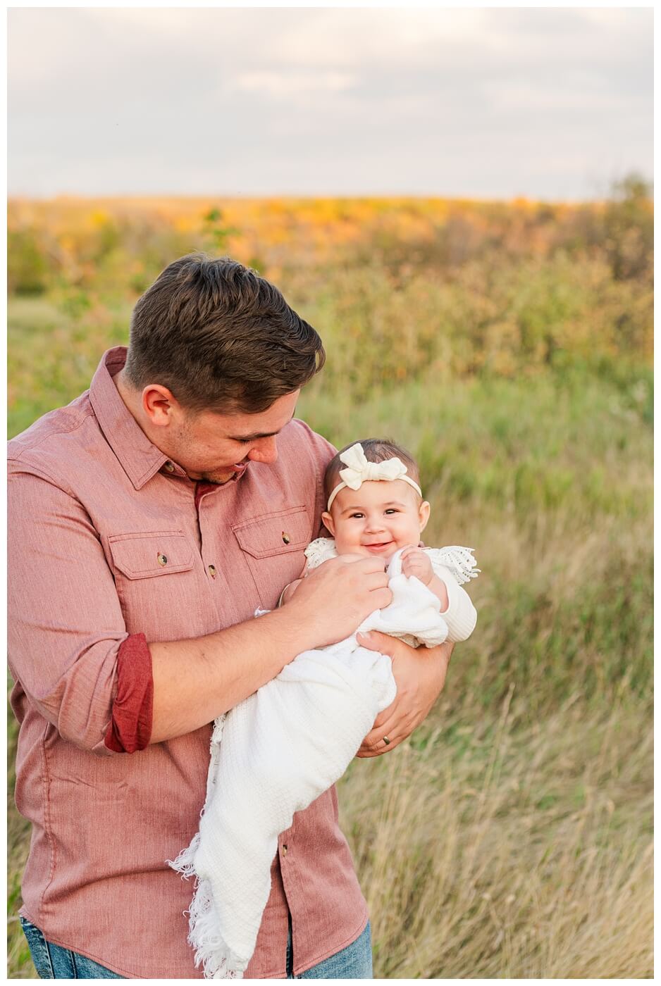 Hachkewich Family - Wascana Trails - 11 - Baby girl smiles in her dads arms