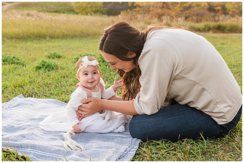 Hachkewich Family - Wascana Trails - 12 - Mom sits on blanket with baby daughter